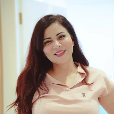 Naila Khanfir, Head of LipoLab, in a blush pink clinic top